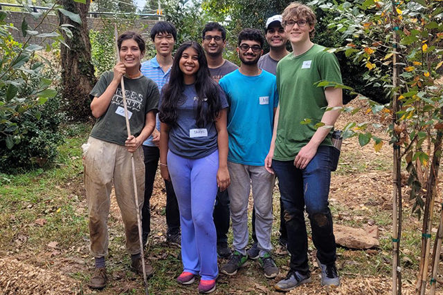A groups of GT volunteer students with a Trees Atlanta leader in a park.